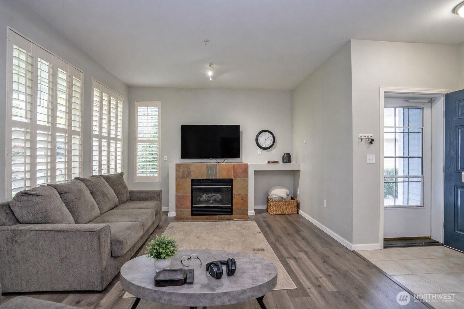 Welcome home—beautiful shutters and an electric fireplace create a warm, inviting space that instantly feels like home.