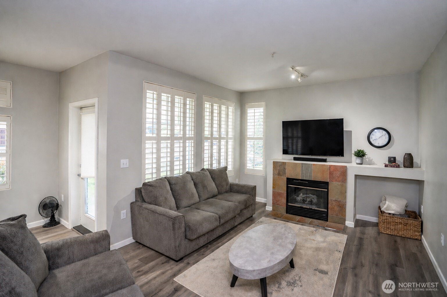 Another view of the living area, featuring a glass door to the left that opens to the covered patio.