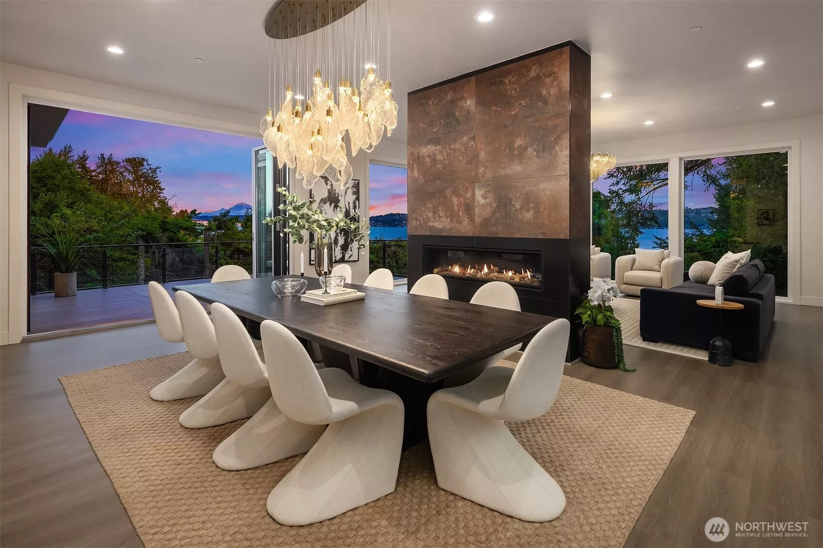 Open-air dining meets cozy fireside living, framed by sunset views over Lake Washington and Mount Rainier