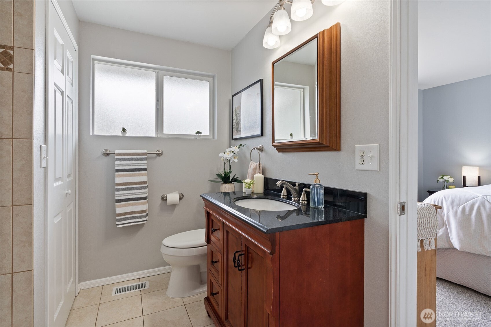 Bathroom can be accessed from the hallway and the primary bedroom