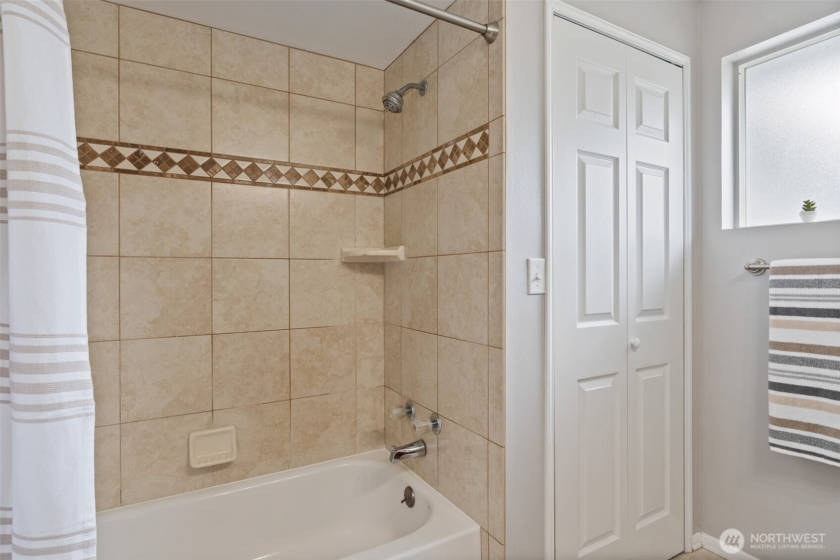 Updated bathroom with tile shower, flooring and updated vanity, light fixture etc.