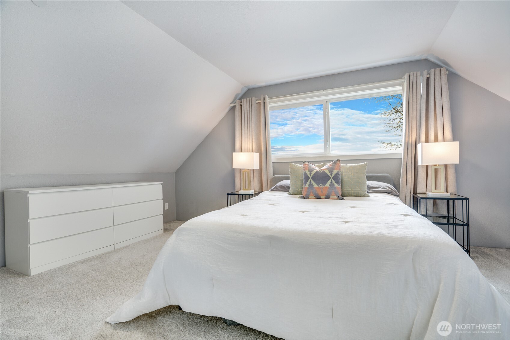 Upstairs, the primary bedroom offers added privacy