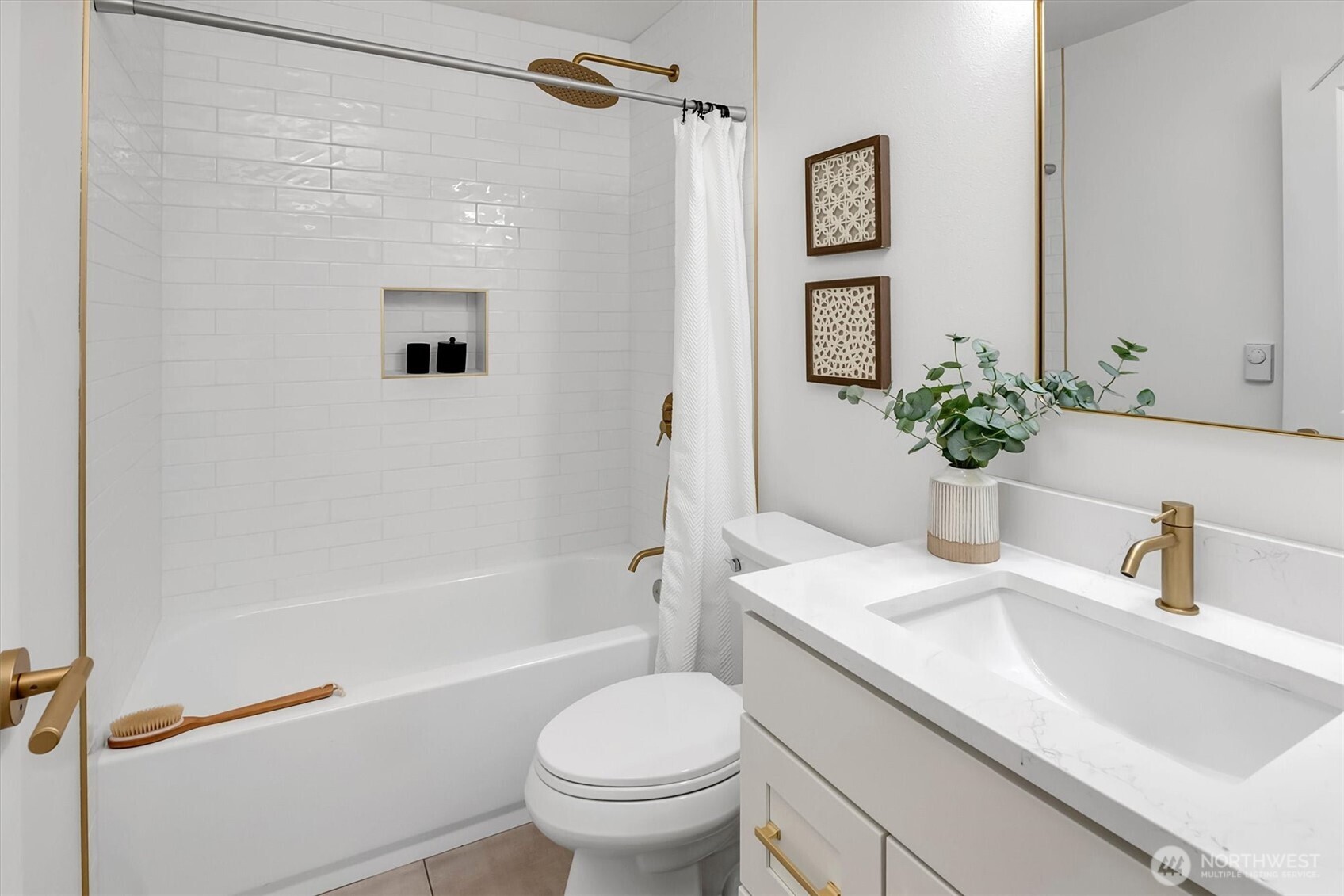 Bathroom featuring tub with tiles walls and ceramic floor tiles.
