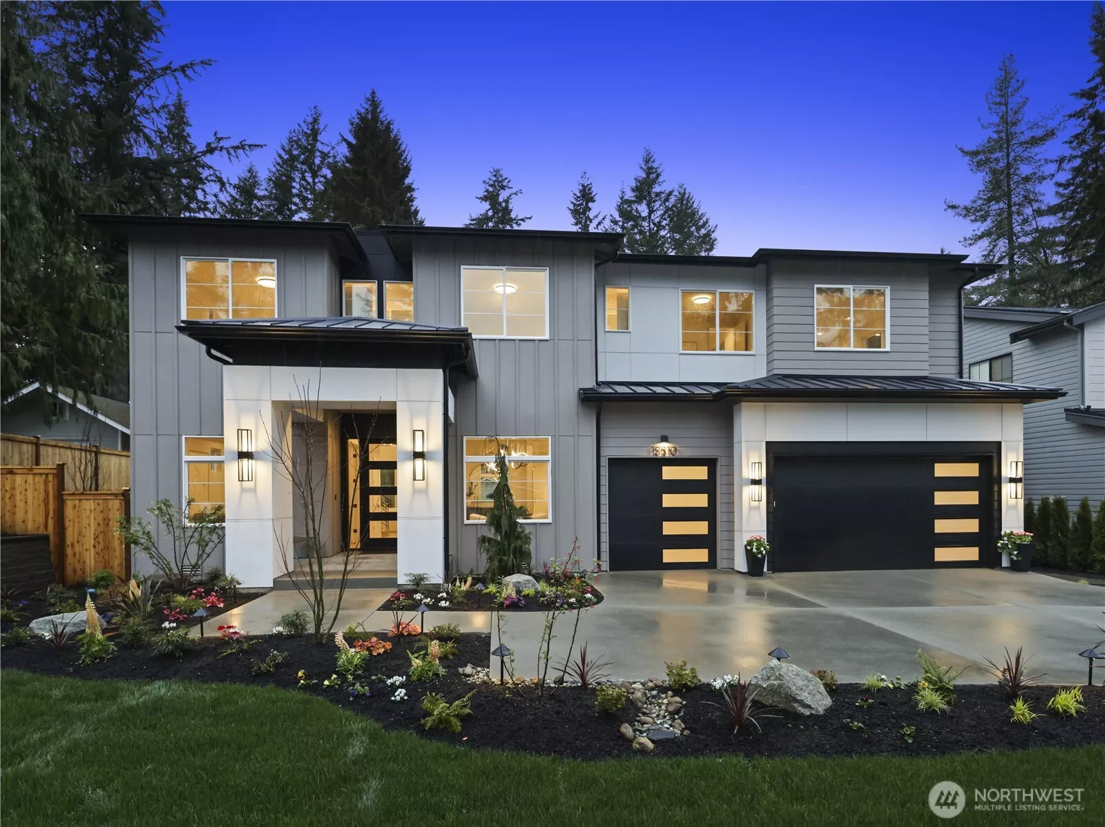 Front Exterior: Hamish Anderson Custom Homes presents a one-of-a-kind NW Contemporary home in North Rose Hill. Expansive, approx. 10,000 sq. ft. homesite, a covered front porch, and a three-car garage.