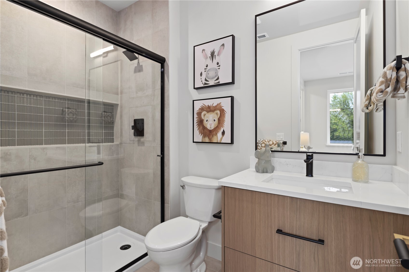 Ensuite bathroom with nice long shower and full-length inset champoo niche with accent tiling.