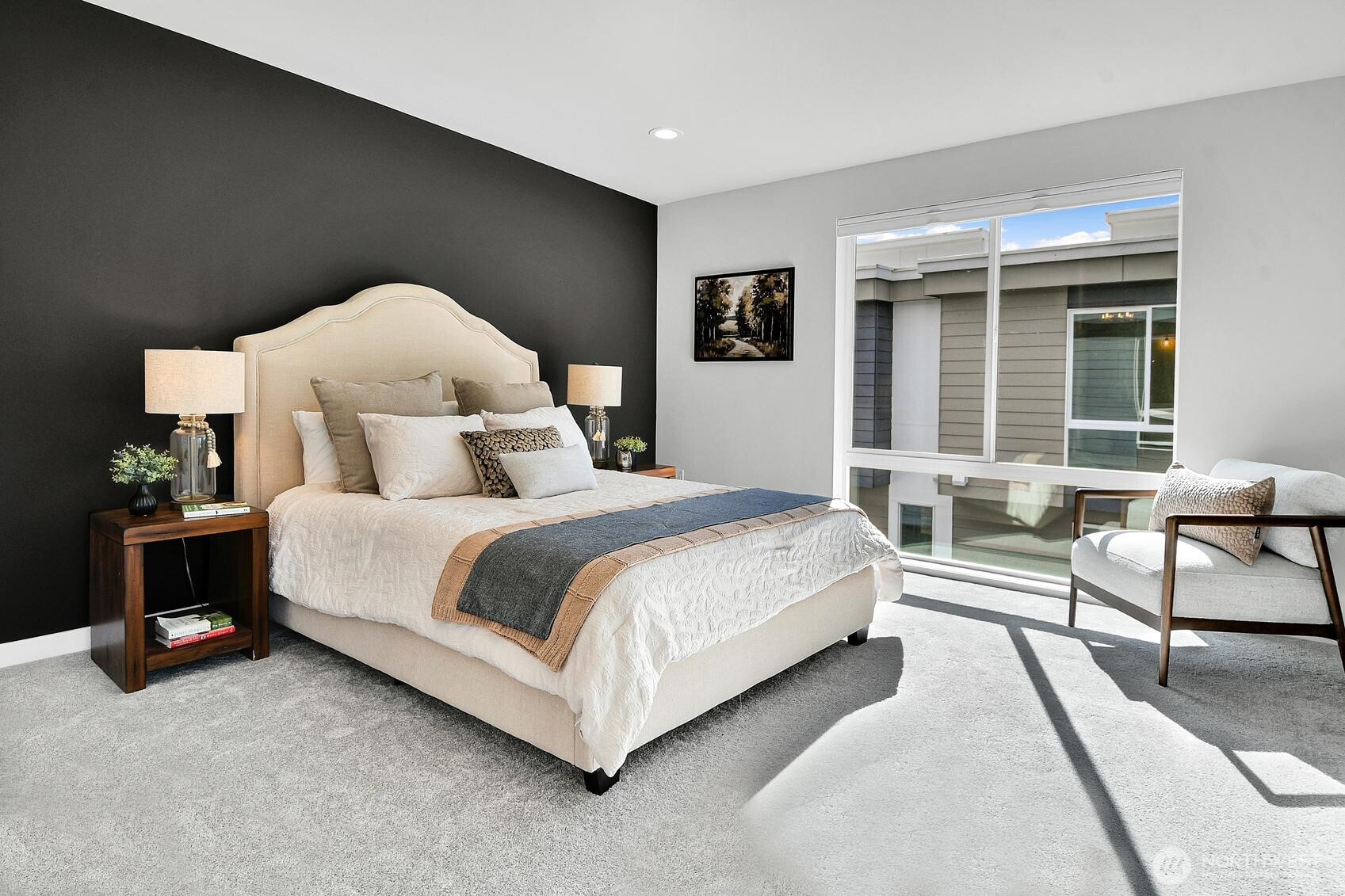 The Primary bedroom has a floor-to-ceiling window that floods the room with light, as well as a walk-in closet and its own 3/4 bath.