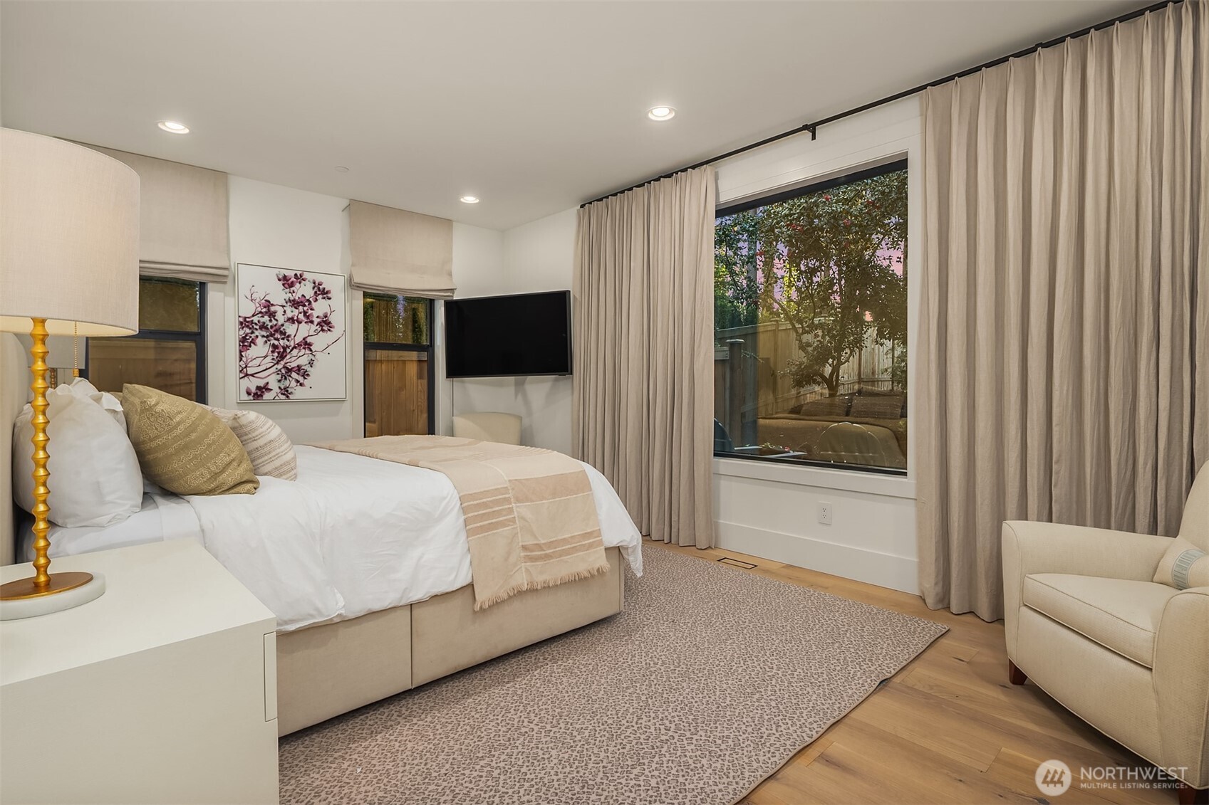 A well-appointed main-floor guest suite with linen drapery, wide-plank white oak floors, and its own private outdoor access. Guests arrive as visitors and leave wishing they could stay longer.