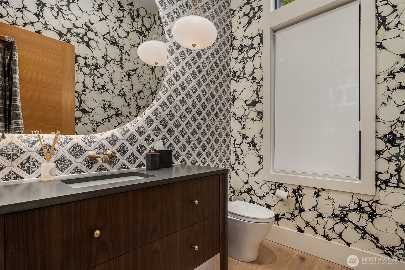 A powder bath with genuine personality — bold wall coverings & geometric tile backsplash - Paquette's touch is felt in every detail, right down to the smallest room in the house.