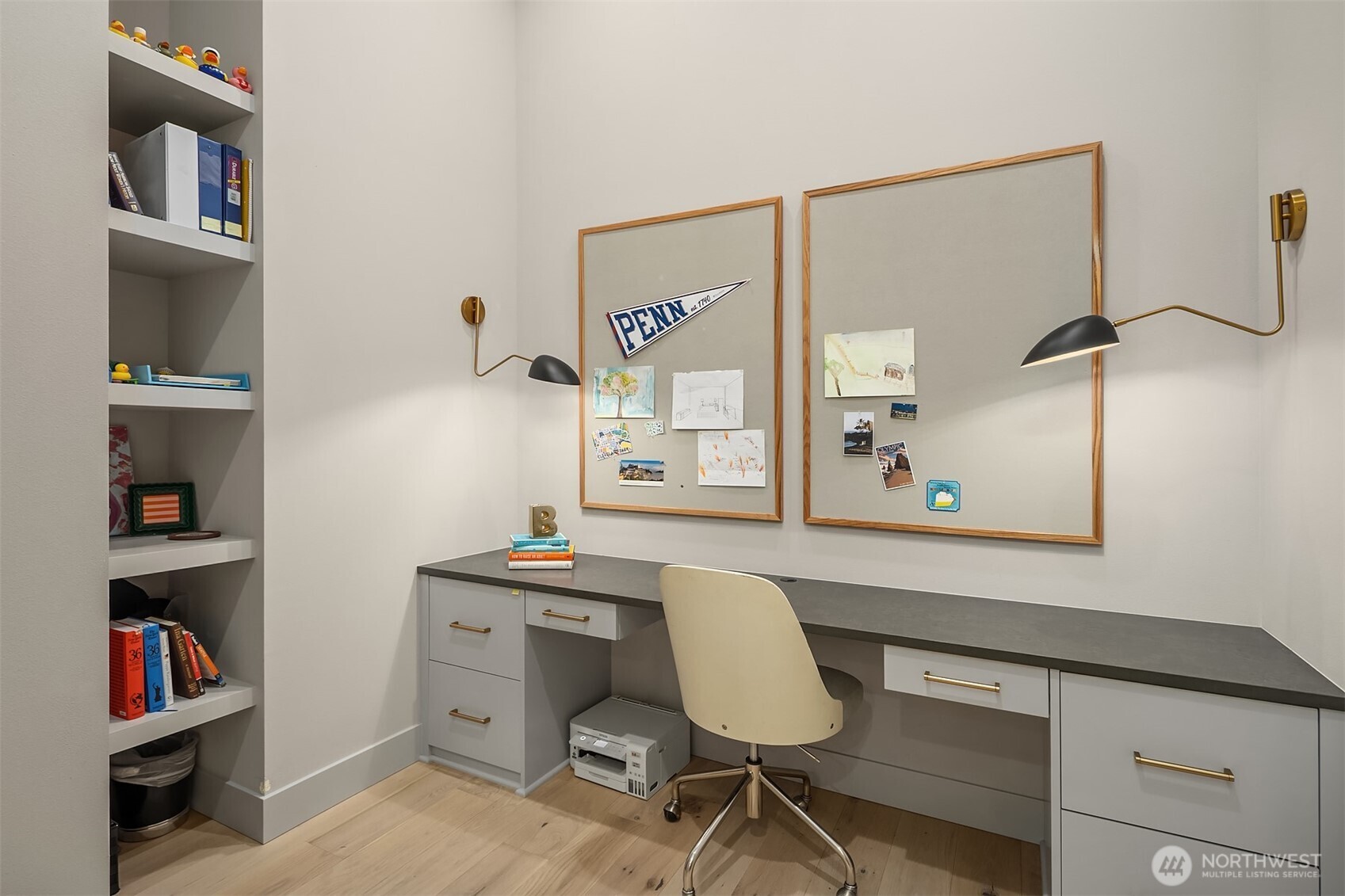 A dedicated built-in workspace with generous counter space and open shelving — the homework nook that actually gets used.