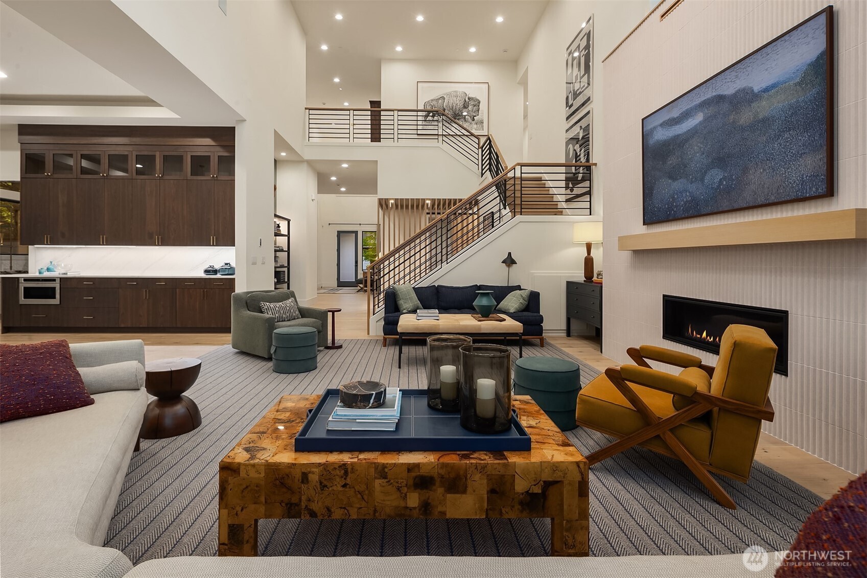 Soaring two-story volume, linear gas fireplace, and a staircase that earns a second look. The kind of room that feels just as good with a full house as it does on a quiet evening.