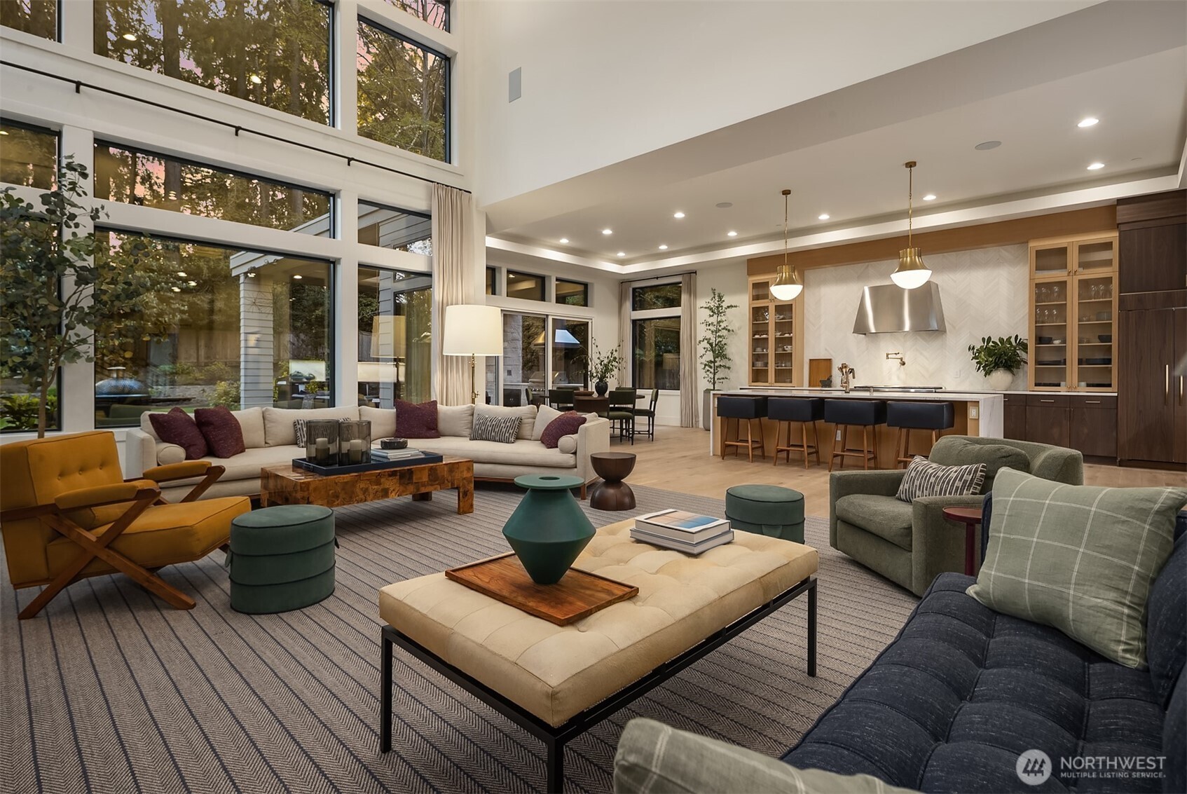 Dinner on the island, drinks in the great room, and the terrace just beyond the glass — the main floor was made for the kind of evening that starts at six and ends well past midnight.