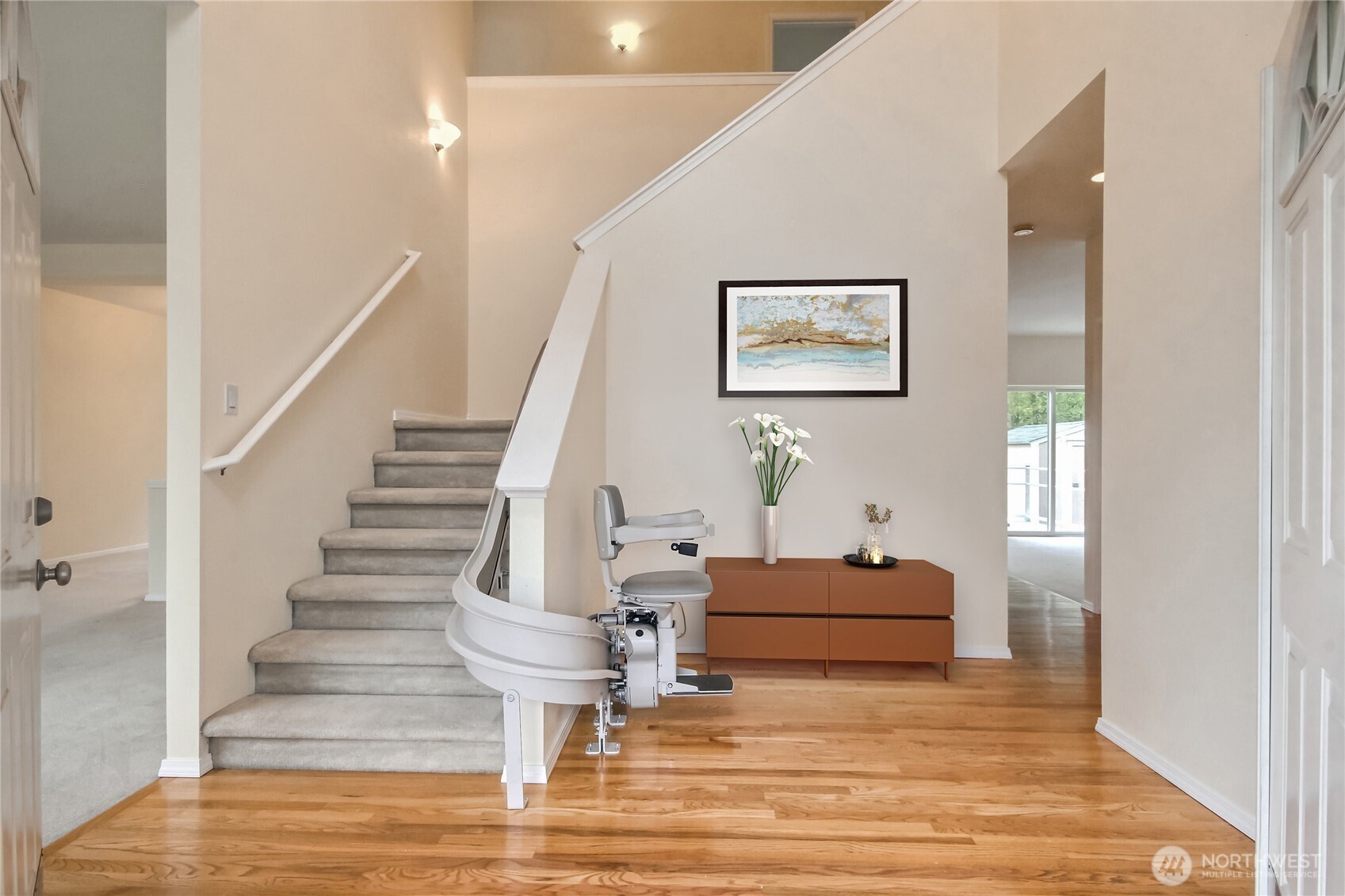 Vaulted ceiling entryway. installed lift-chair. virtual stage with console and wall art area