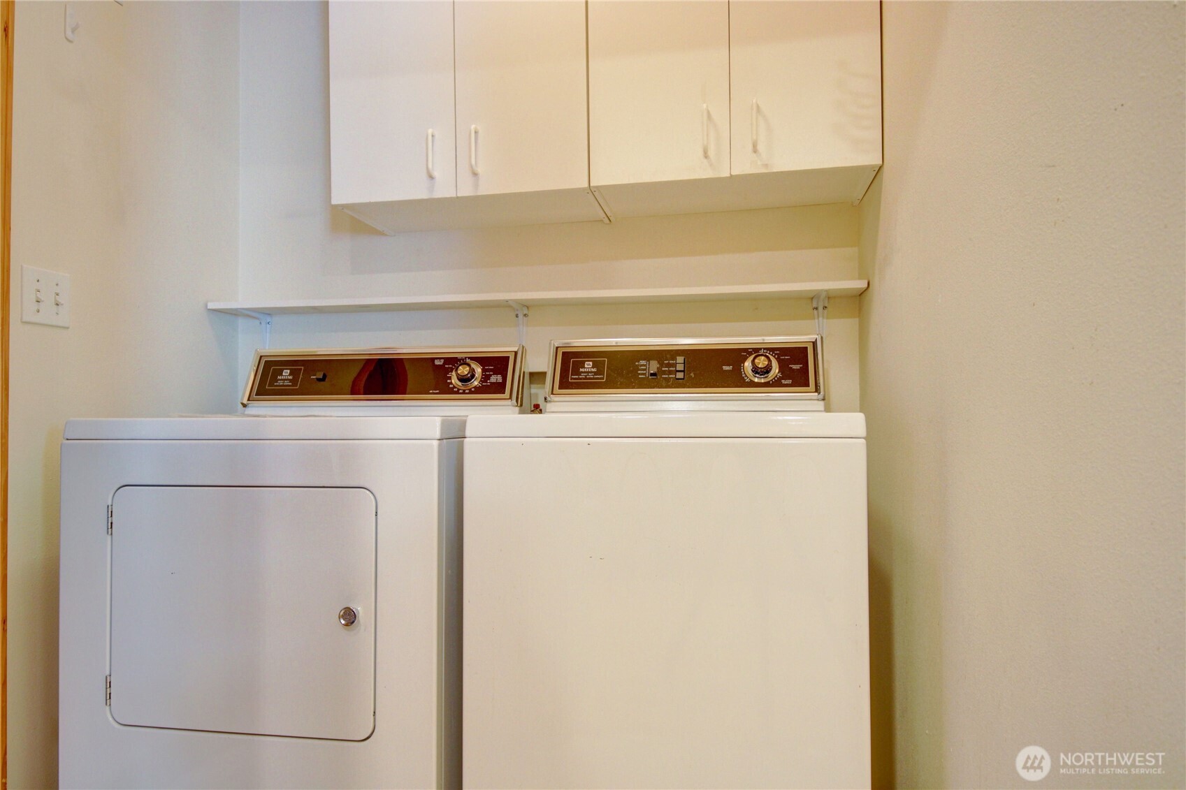 Laundry room with matching washer & dryer, extra storage and access to garage.