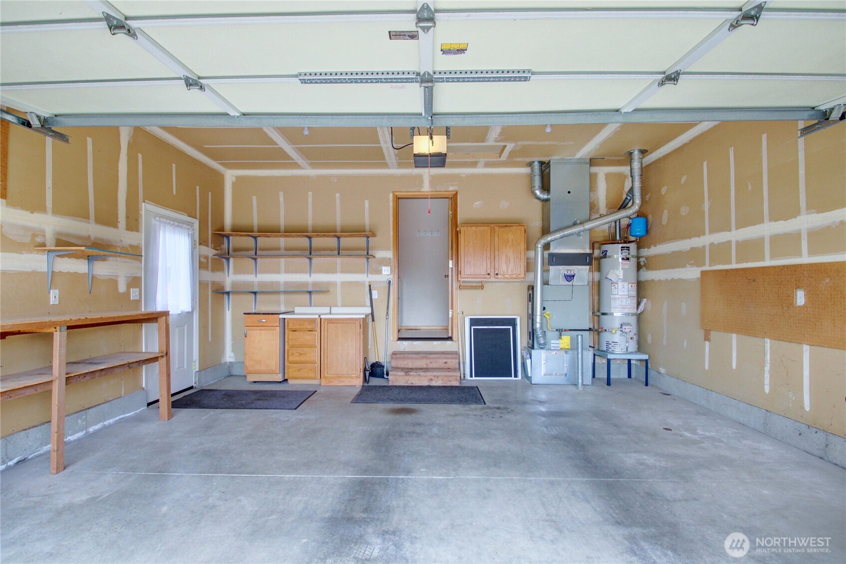 Garage with extra storage and side door.