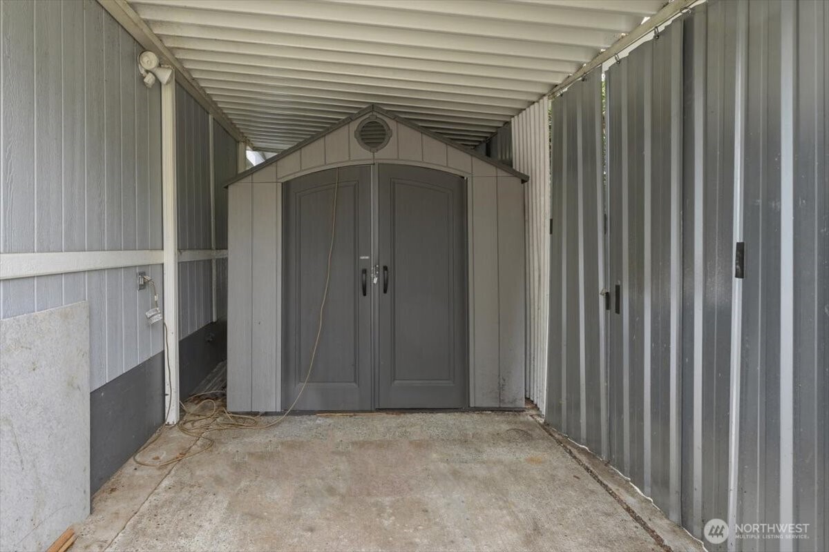 Shed in covered area at front of the unit.