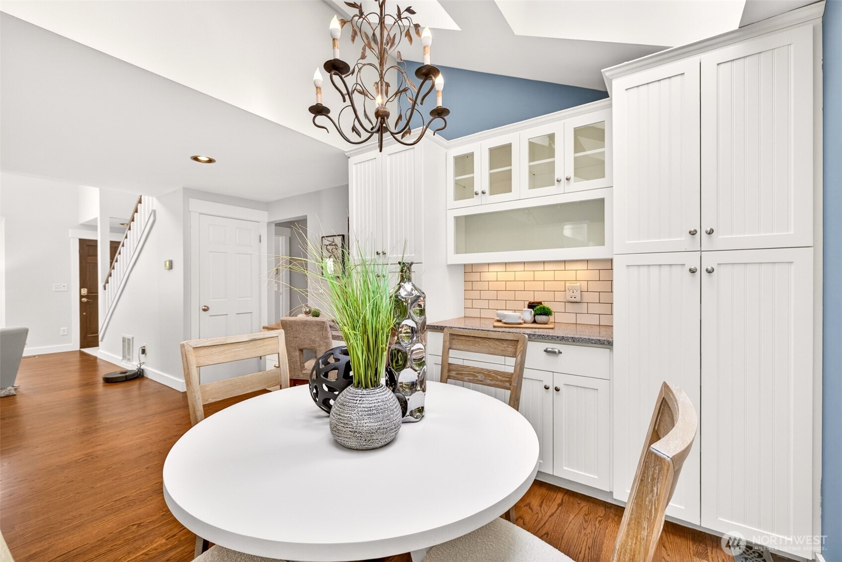 A dedicated dining nook anchored by an updated built-in hutch with glass-front display cabinetry brings craftsman-quality storage and timeless character to everyday meals.