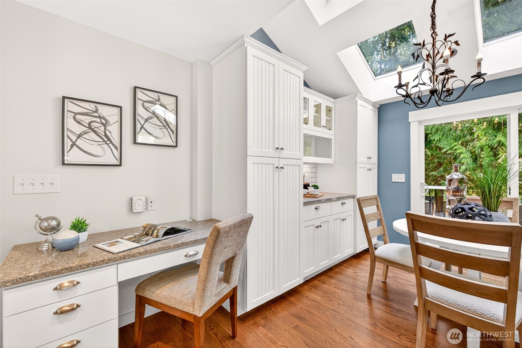 A built-in desk with granite counter and custom cabinetry creates a thoughtful work-from-home zone tucked just off the kitchen, perfect for managing the day from the heart of the home.