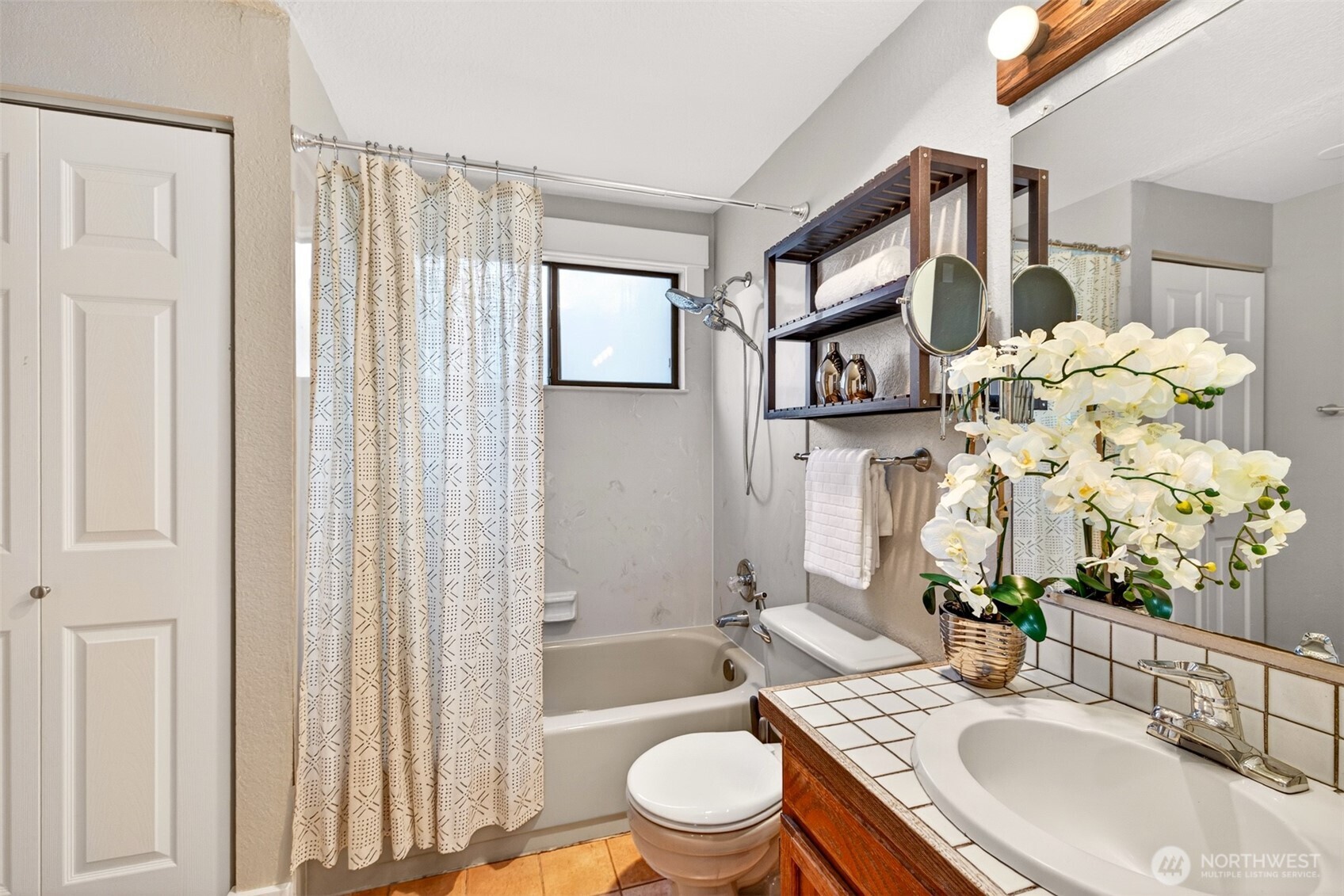 The full main-floor bath features a tub-shower combination and bright, functional layout, ideally positioned to serve both bedrooms and guests with ease.