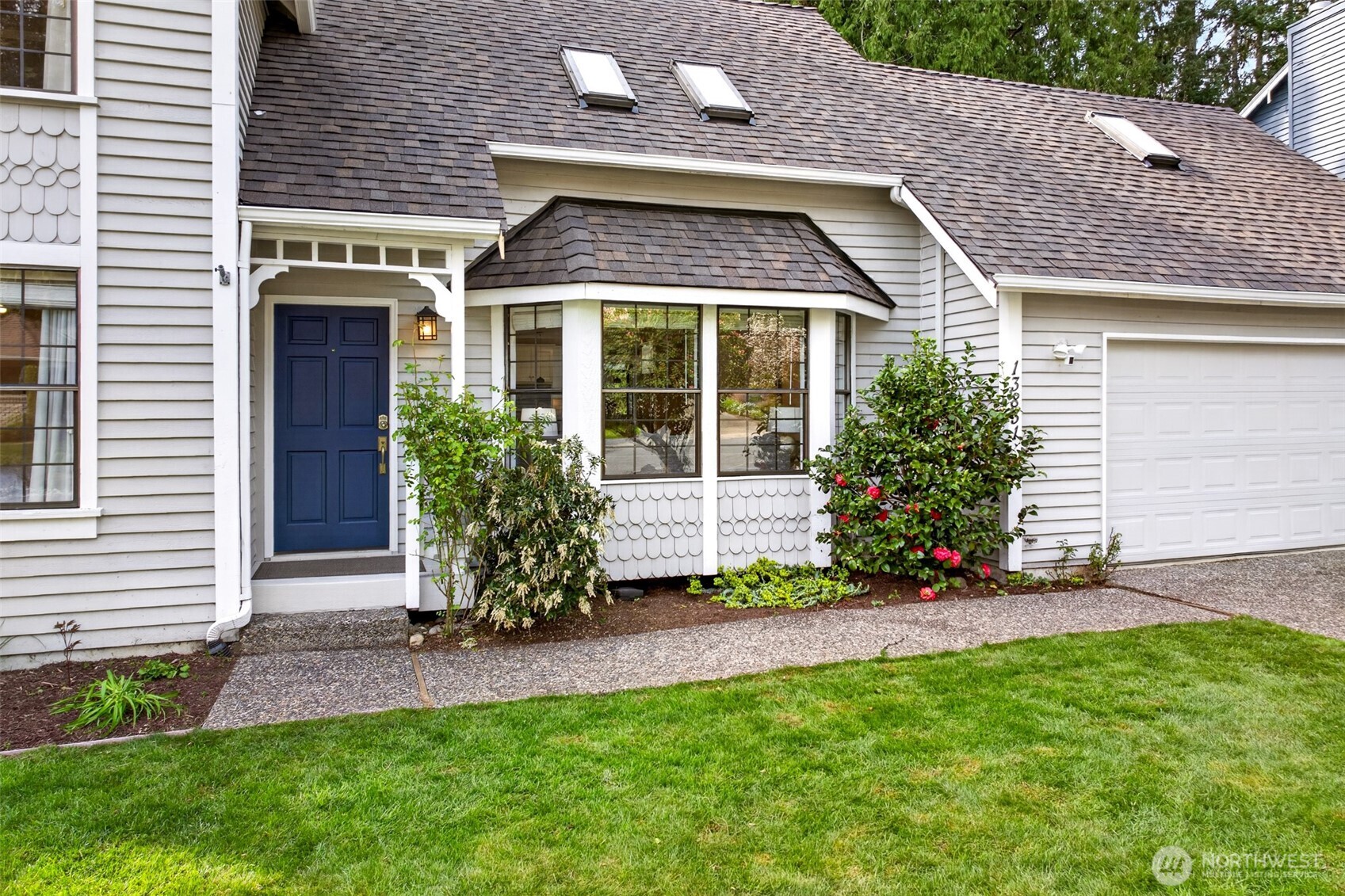 A covered entry, blooming camellias, and charming bay window detailing create an inviting welcome that sets the tone for the warmth and craftsmanship found inside.