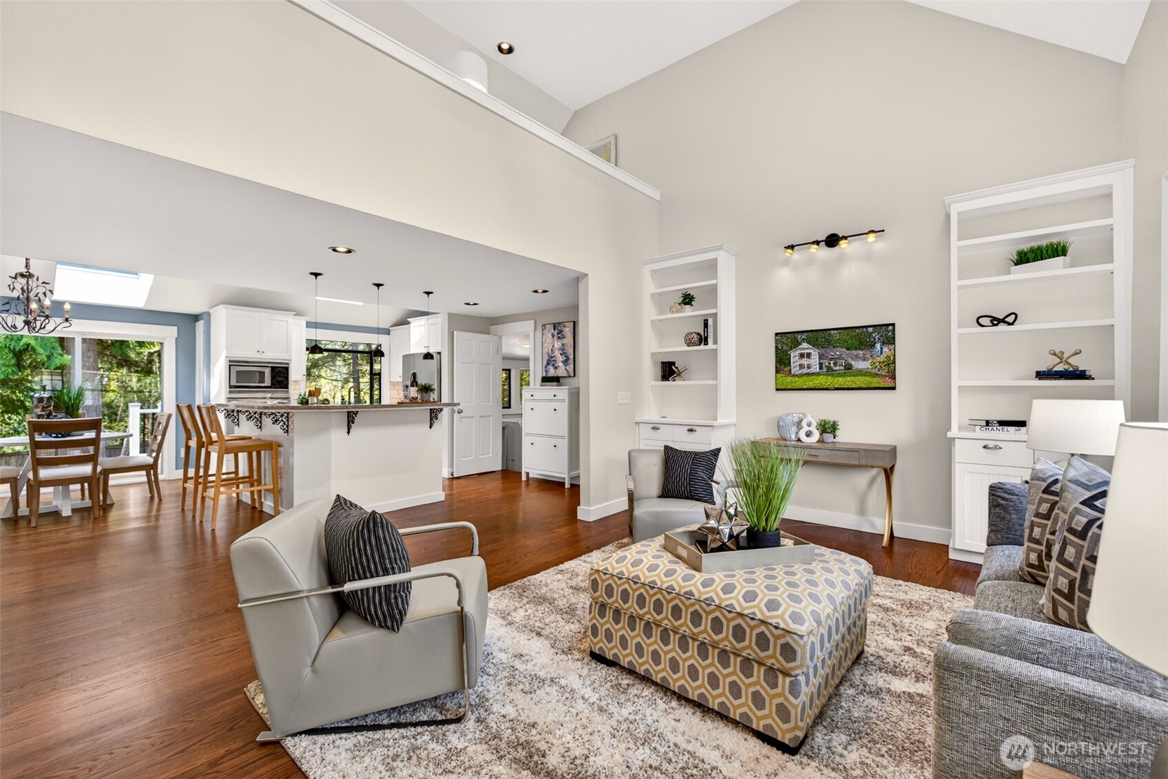 Soaring vaulted ceilings, gleaming hardwoods, and seamless flow from the living room to the updated kitchen and dining area set the stage for effortless daily living and easy entertaining.