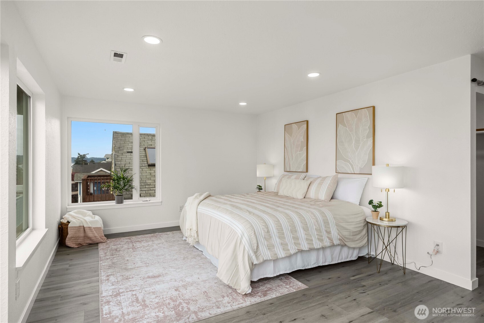 Primary suite w/sweeping views of the Puget Sound, large walk in closet spans the entire wall behind the bed