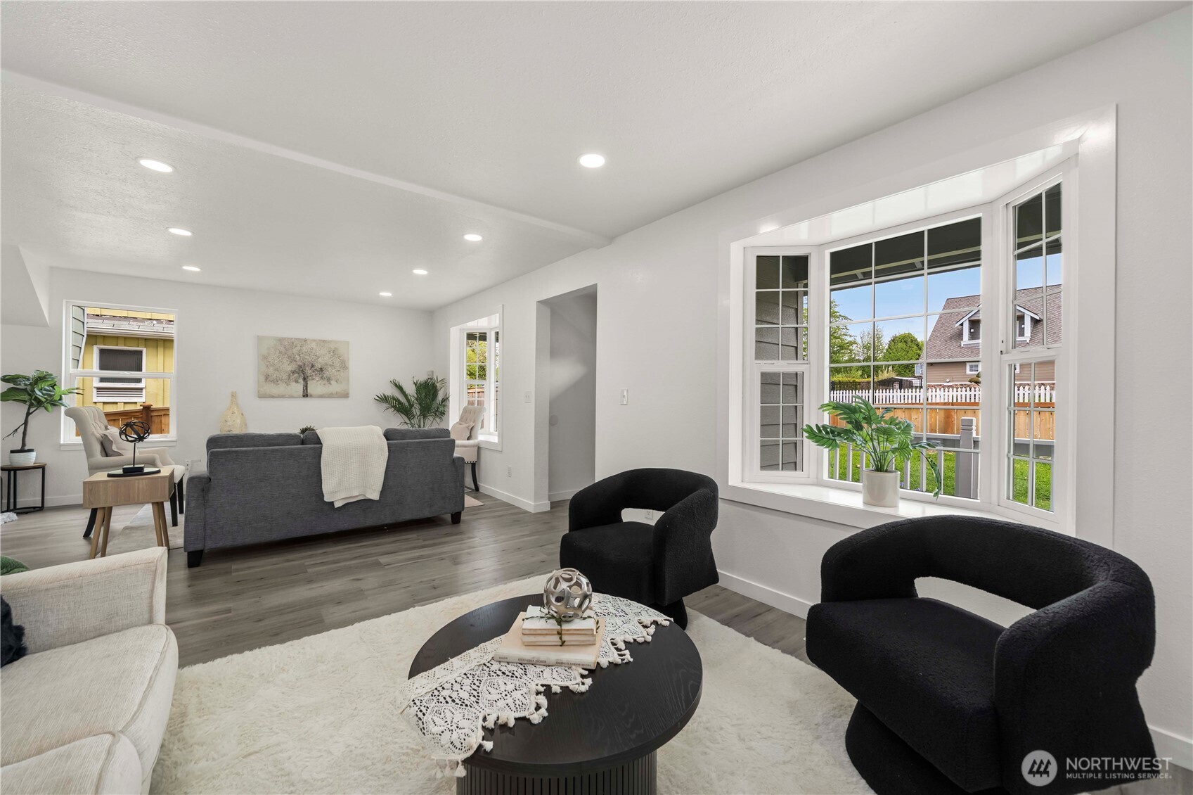 Great view of the bay windows and the living room, including the covered front deck and new front fencing