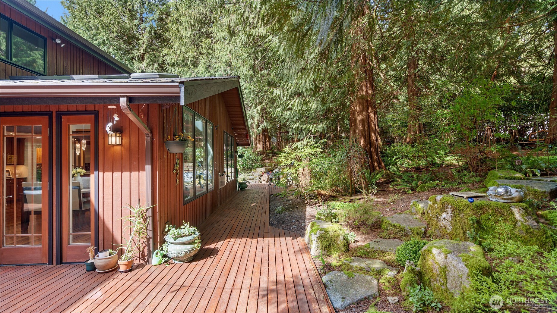First, your eye is drawn to the 5-person spa, ready for a relaxing soak at the end of the day. Beyond it, the charming shed with its front door and peaked roof adds a delightful touch, while a second shed behind the spa offers convenient everyday storage.