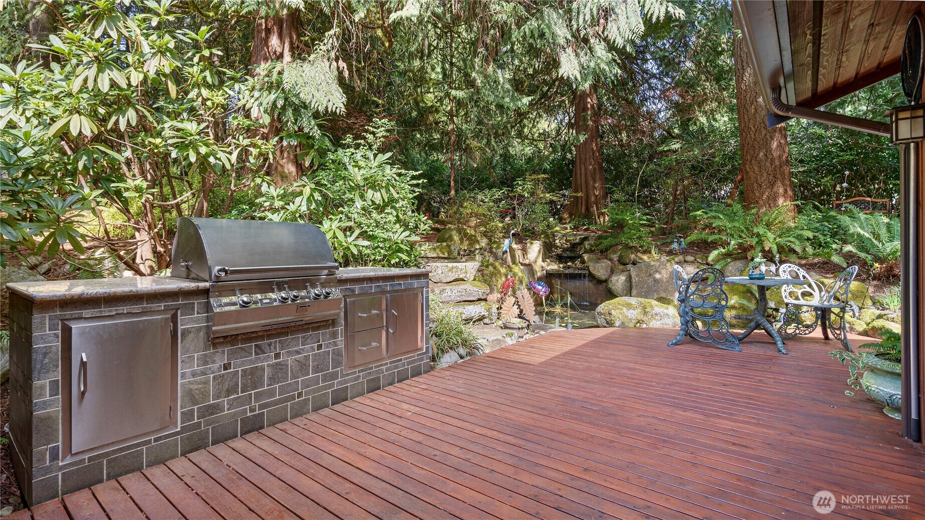 As you make your way around the back of the house, notice the stone steps leading up into the forest. With pathways to wander and tucked-away sitting areas to enjoy, this part of the property offers such a soul-soothing retreat... the kind of place that helps the world quiet down for a while.