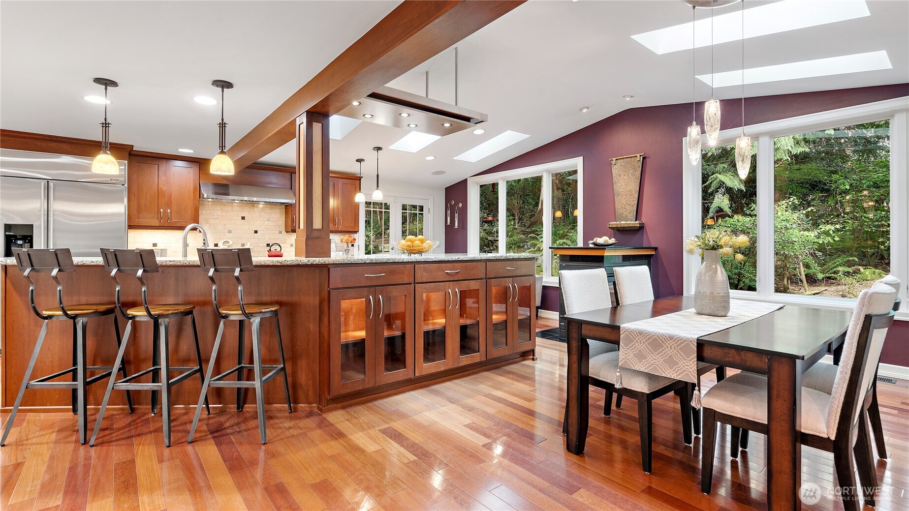Inside, you're welcomed by Brazilian cherry floors that positively glow, bringing richness, warmth, and an unmistakable sense of quality to the space. It’s a beautiful introduction to the level of care and craftsmanship found throughout the home.