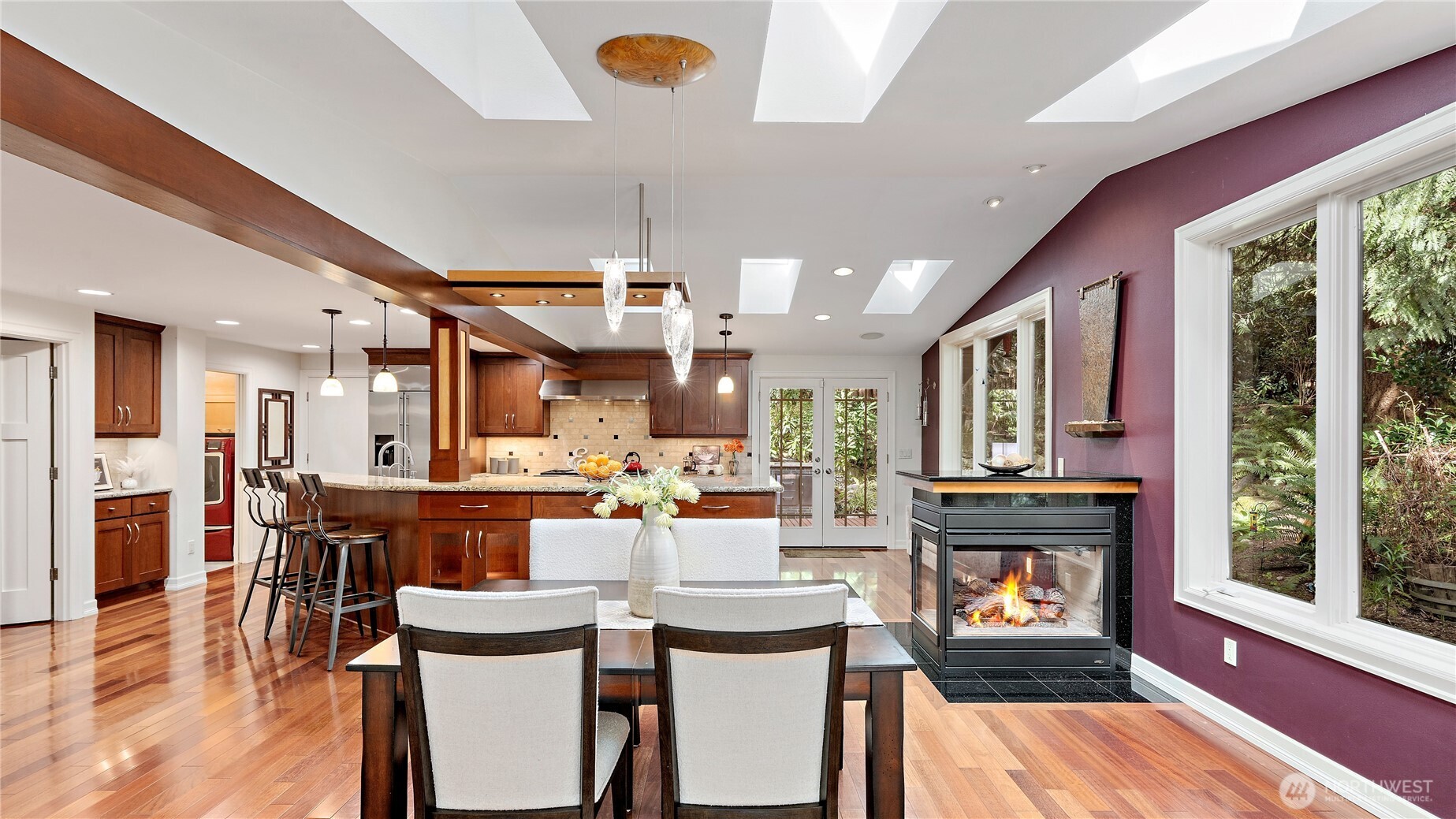 This portion of the home was expanded to create a stunning Norsk-modeled kitchen, where contrasting natural materials, clean lines, and smart storage come together beautifully. The lighted cabinetry below is such a gorgeous detail.