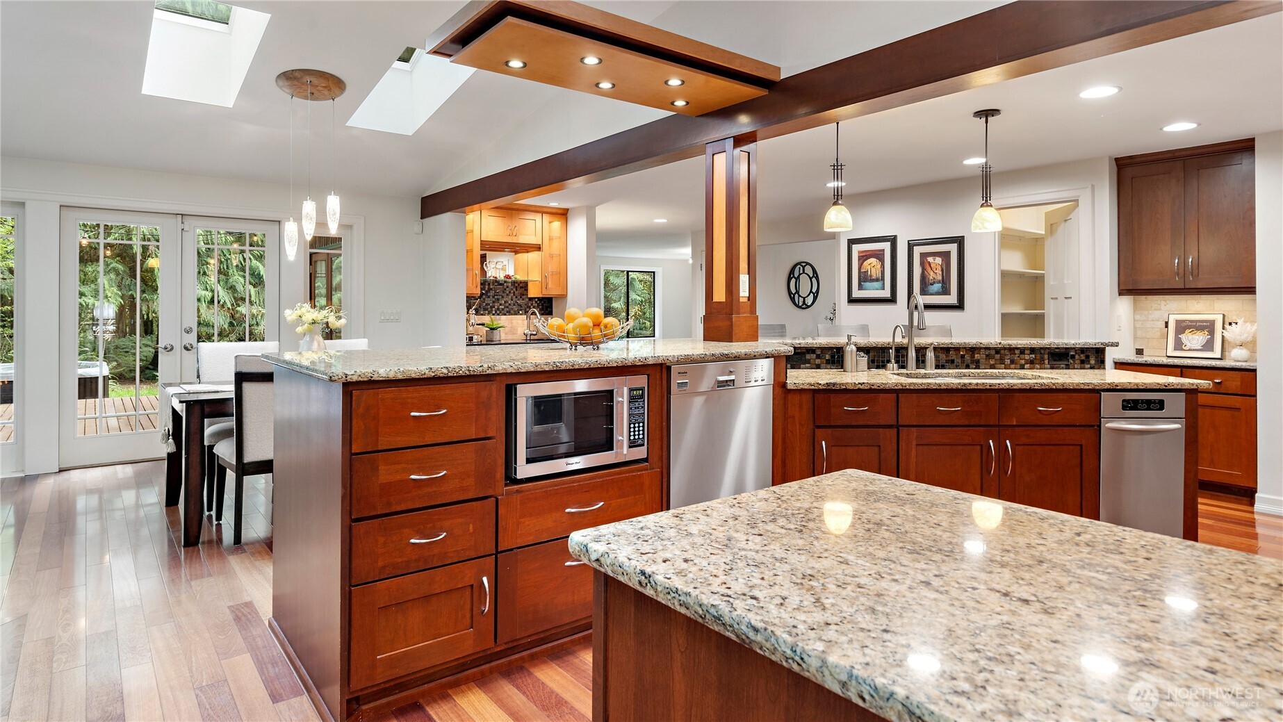 And then there’s the 48-inch dual-fuel Wolf range with dual convection ovens and a griddle... a standout centerpiece for a kitchen that was clearly designed with both beauty and serious cooking in mind.