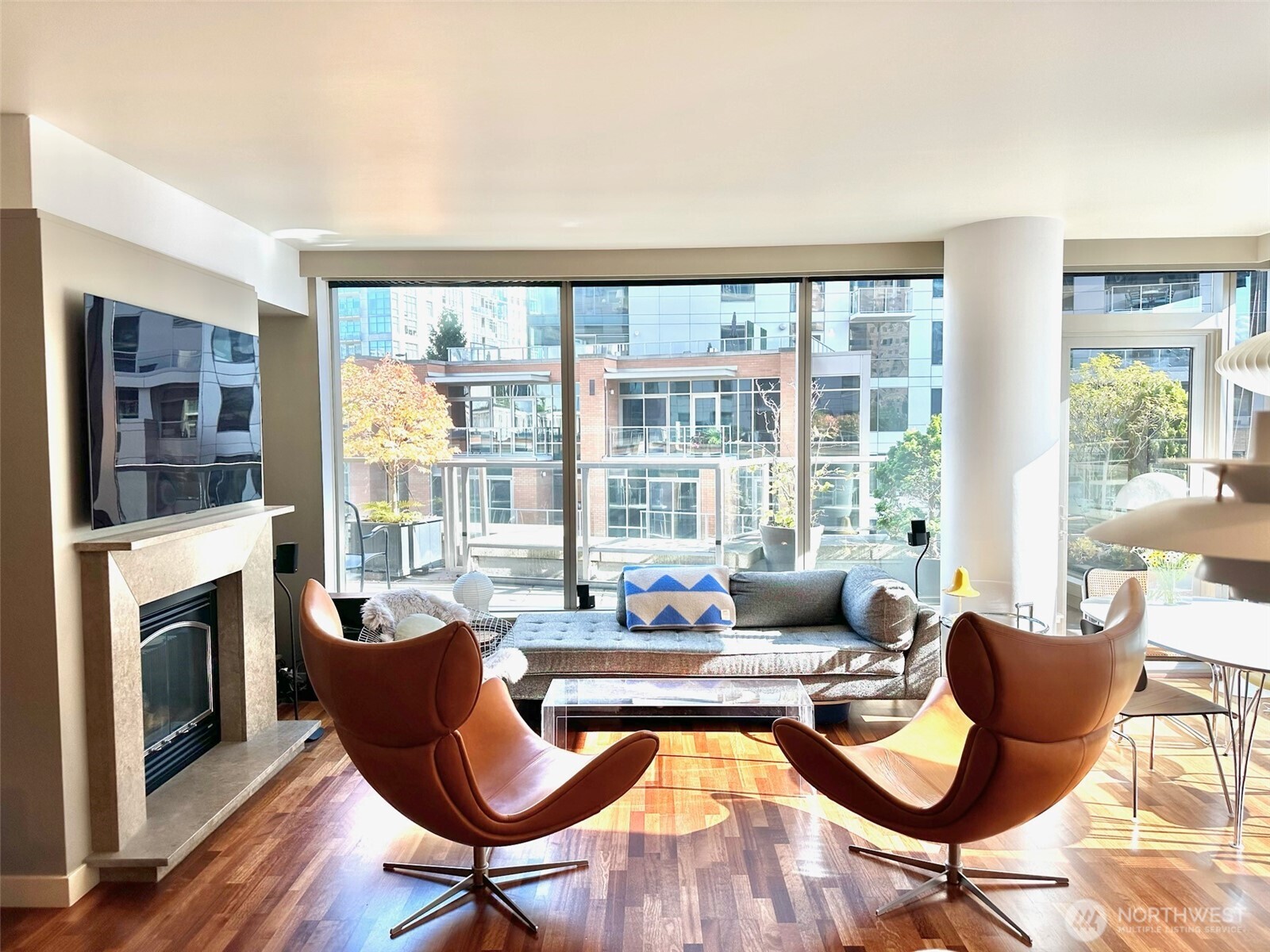 Spacious living area with expansive windows and open layout, perfect for relaxing or entertaining.