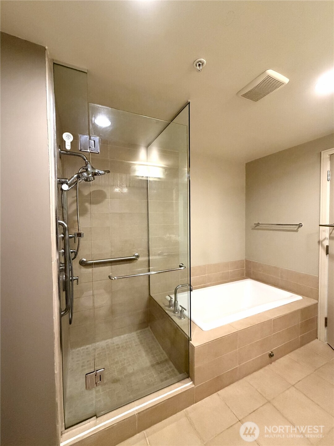 Spa-inspired bathroom with glass-enclosed shower and contemporary finishes.