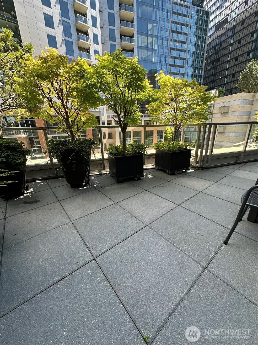 Outdoor terrace with greenery and space for entertaining.