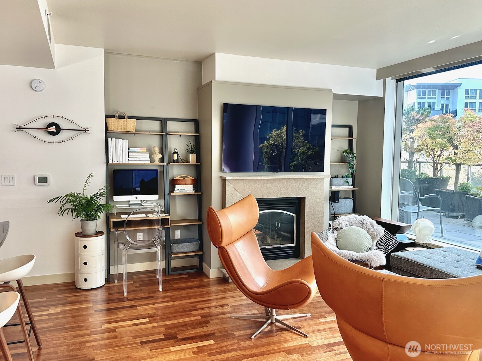 Cozy sitting area with fireplace and large windows capturing natural light.
