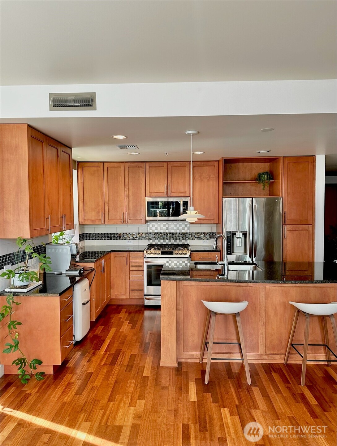 Kitchen with center island and bar seating, ideal for everyday living and entertaining.