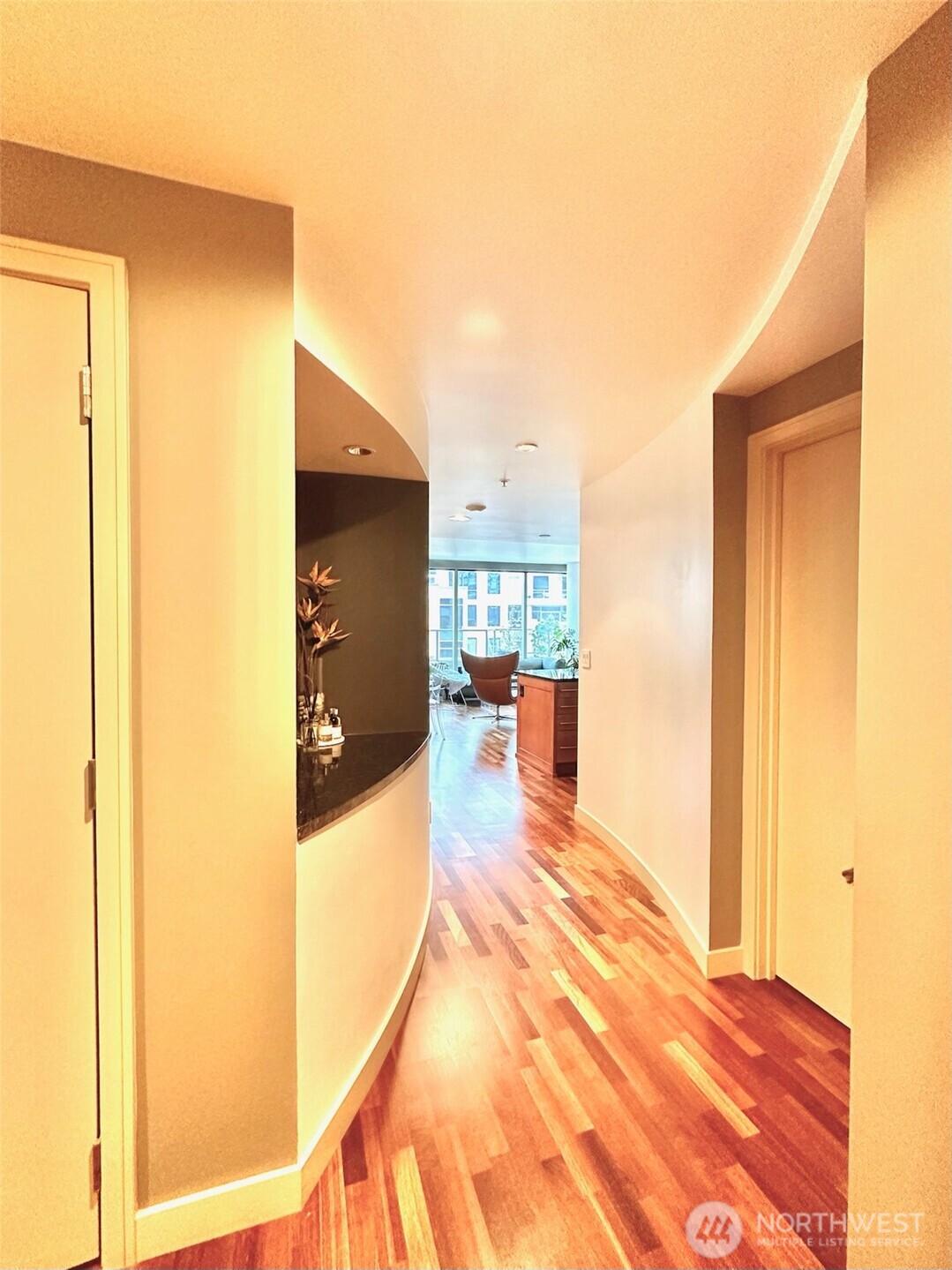 Welcoming entry hallway with clean lines and warm hardwood flooring.