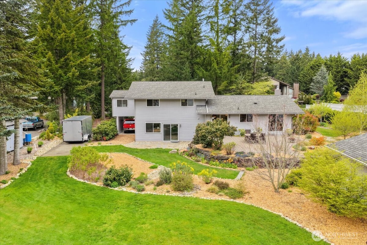 Beautifully landscaped 3/4 acre lot includes flowers, plums, and raspberries!