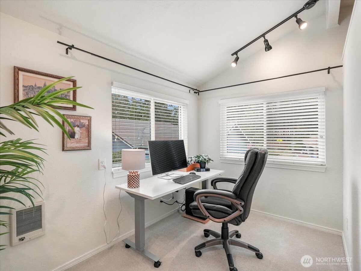 The private windowed space off the primary bedroom could be a home office or quiet retreat to read and relax.