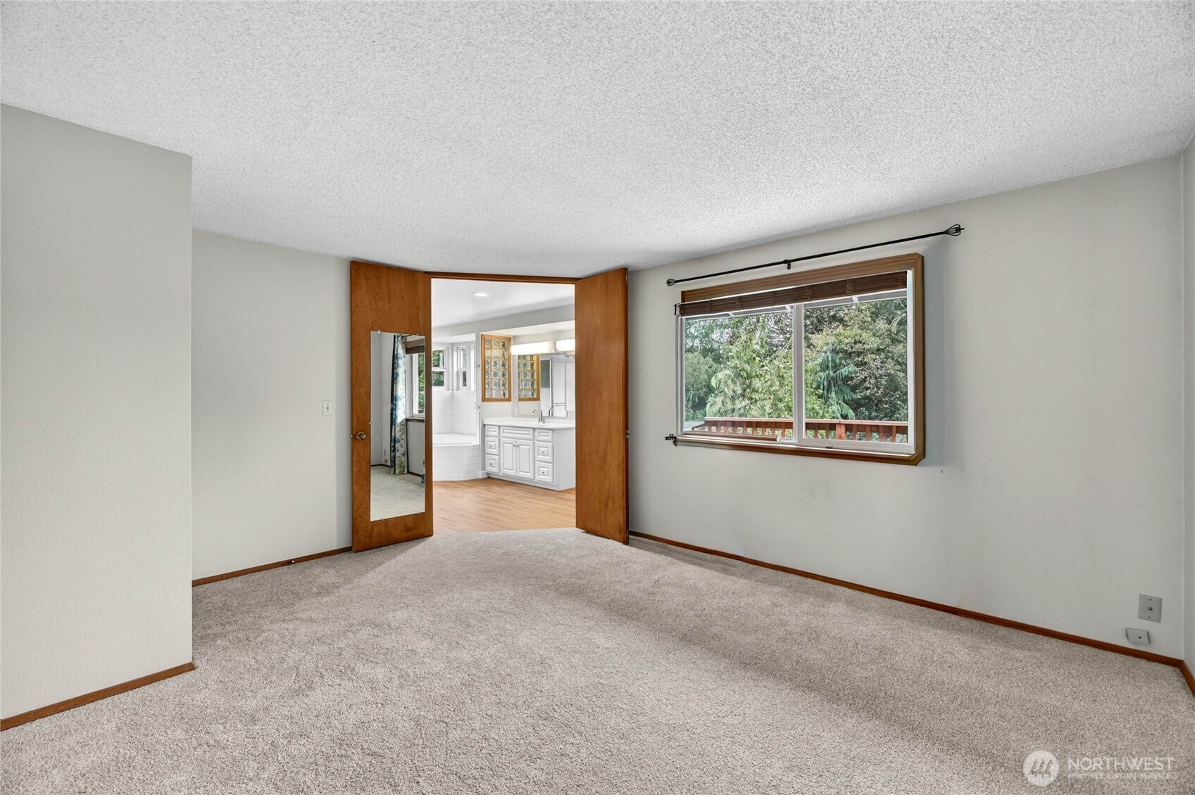 LARGE PRIMARY SUITE  Picture window overlooks rear yard / Ceiling fan