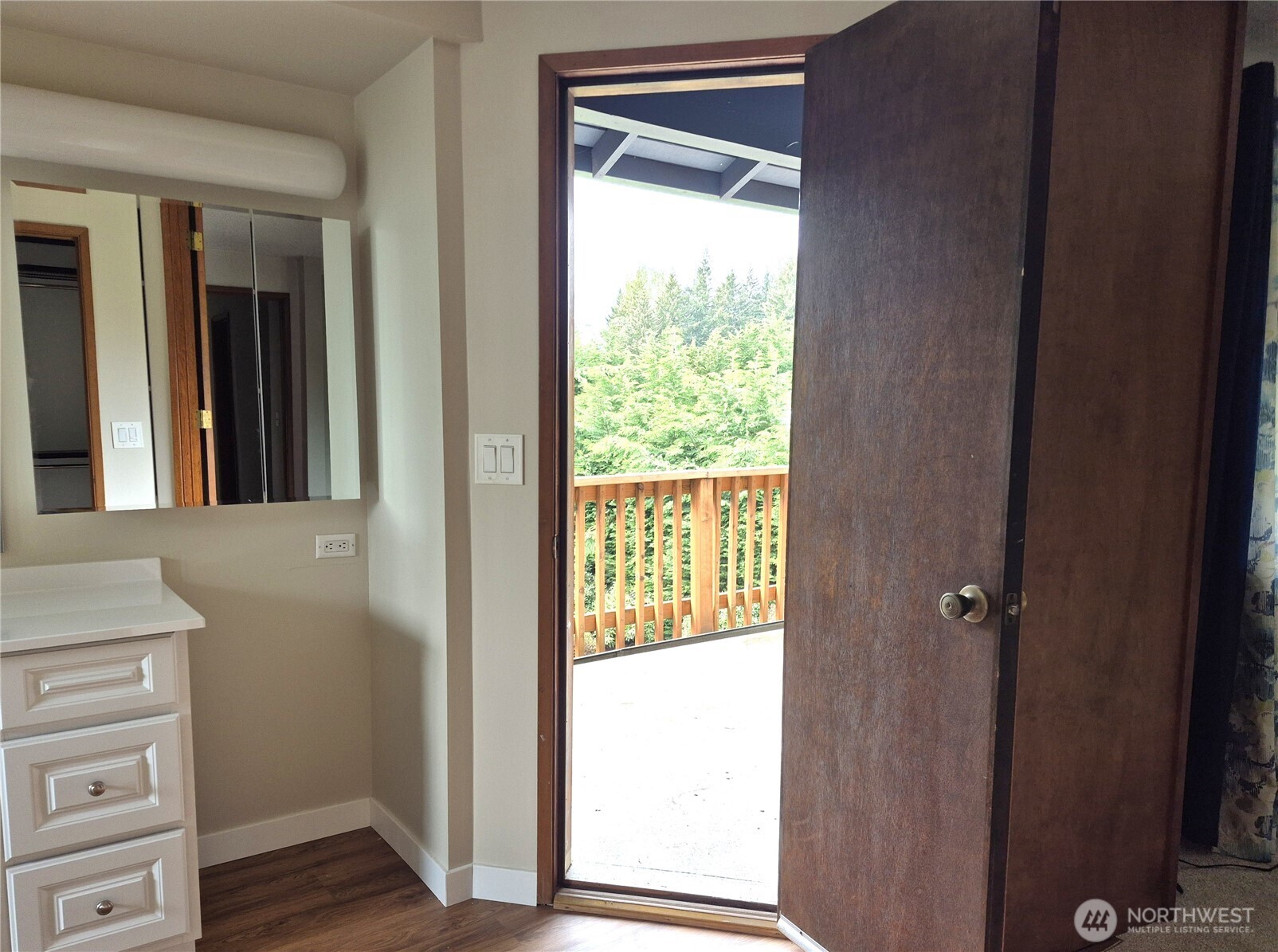 Door leads outside to upper deck with views of luscious private rear yard
