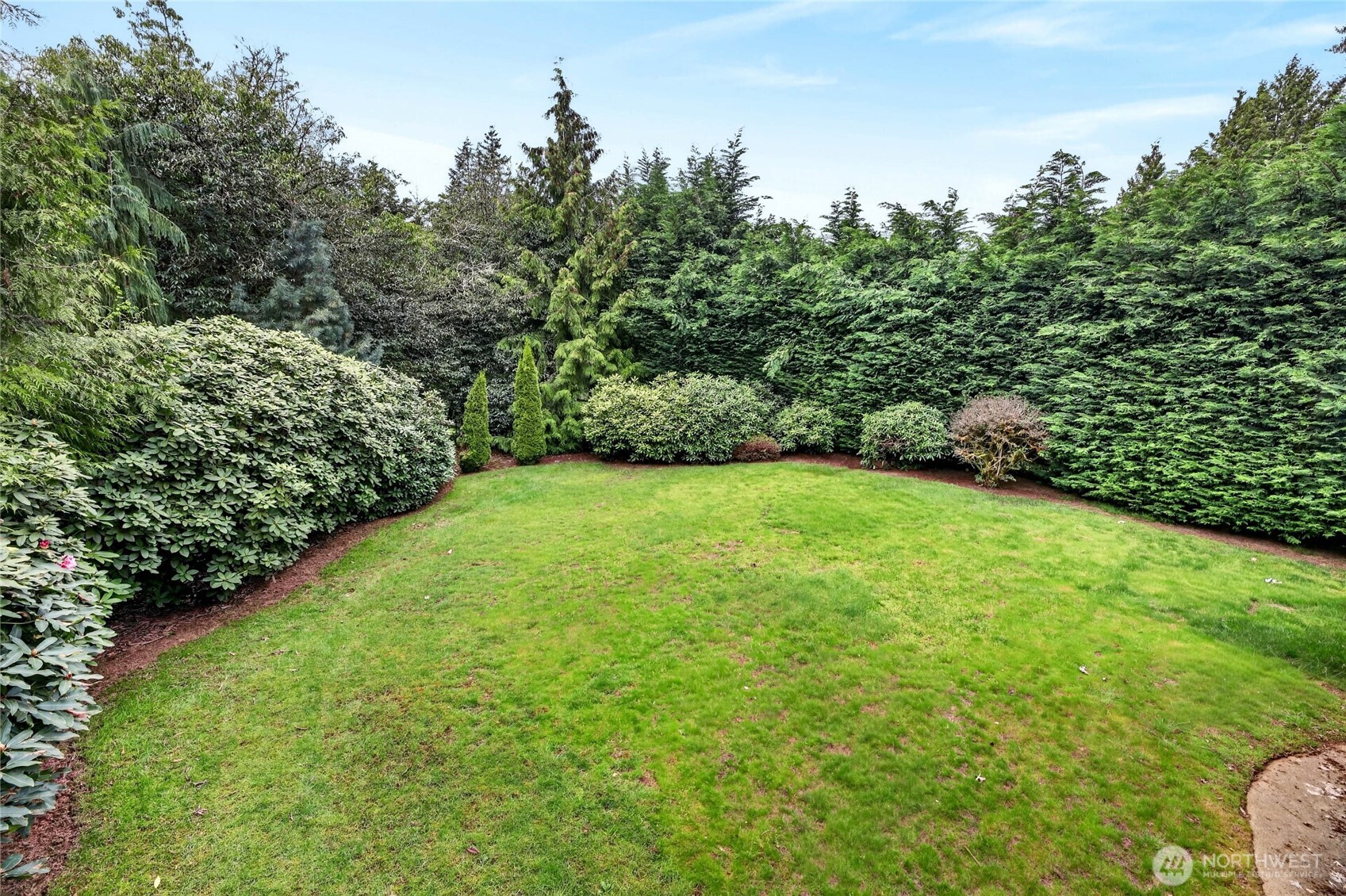 ABOUT THE OUTSIDE  Corner lot  Mature landscaping with double blooming Camila tree, cherry blossom trees, apple trees, hydrangeas and rhodies  Private rear yard with mature trees