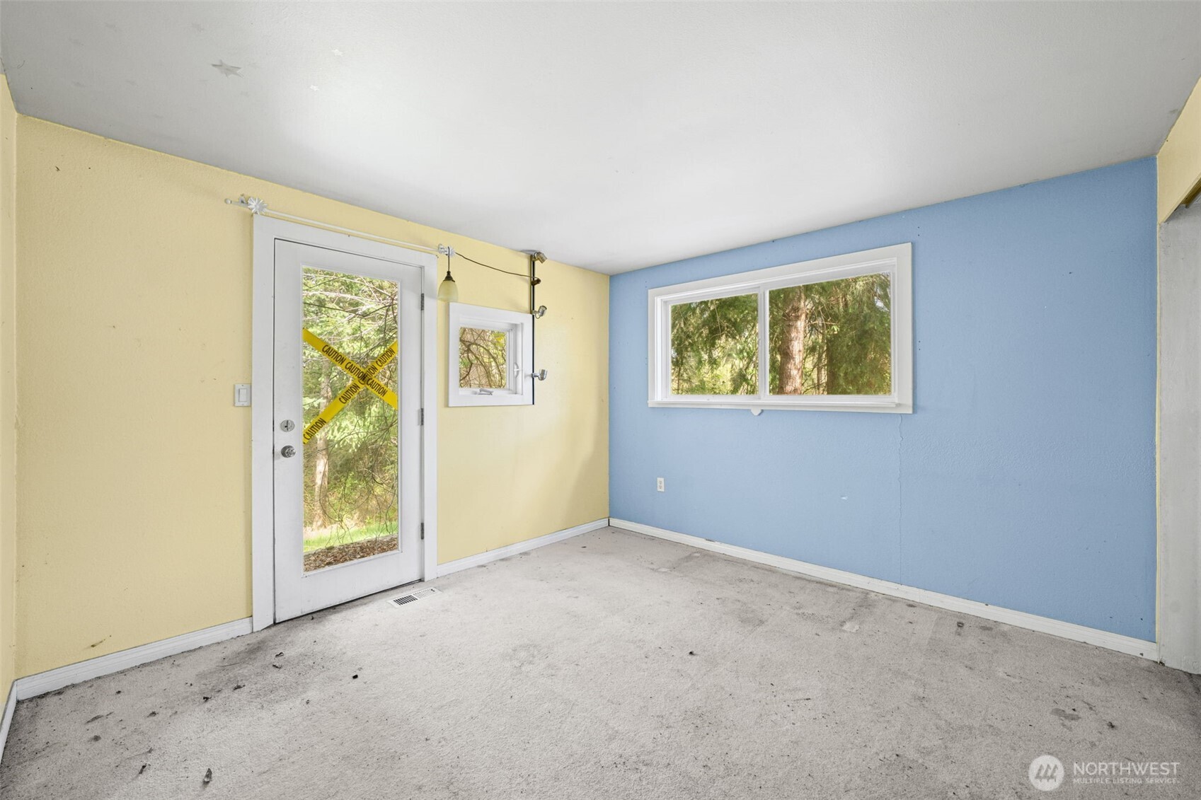Bedroom Two features exterior access and large window bringing in natural light and greenery views. Great opportunity to refresh and customize.