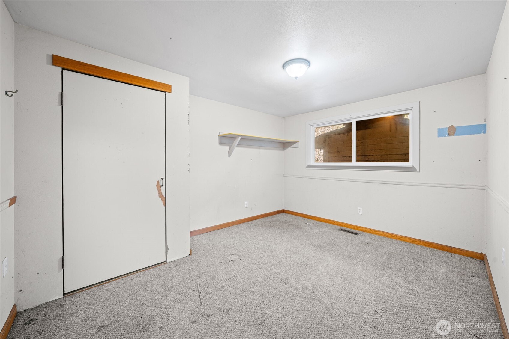 Bedroom Three with closet and window, ready for updates and personal touches. Functional layout ideal for guests, office, or flex space.
