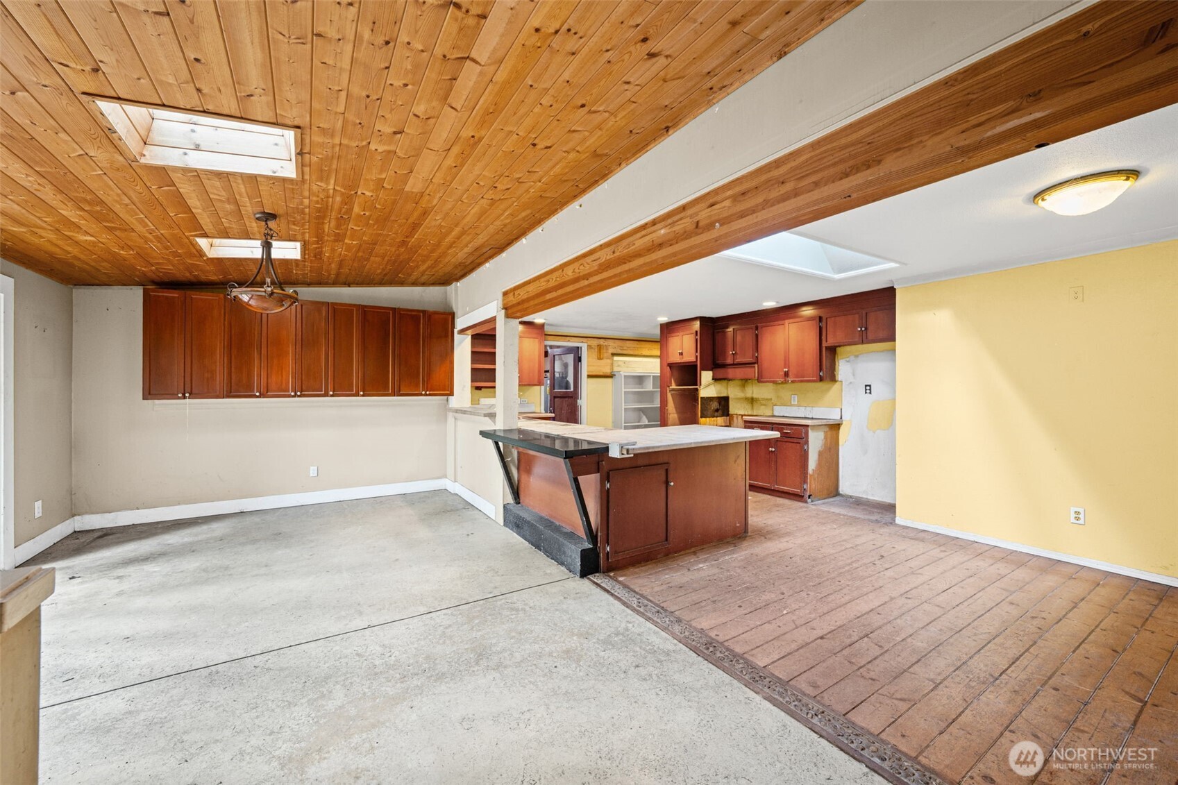 Kitchen layout with existing cabinetry and island offers a strong starting point for a full renovation. Opportunity to design your dream kitchen in an open-concept space.