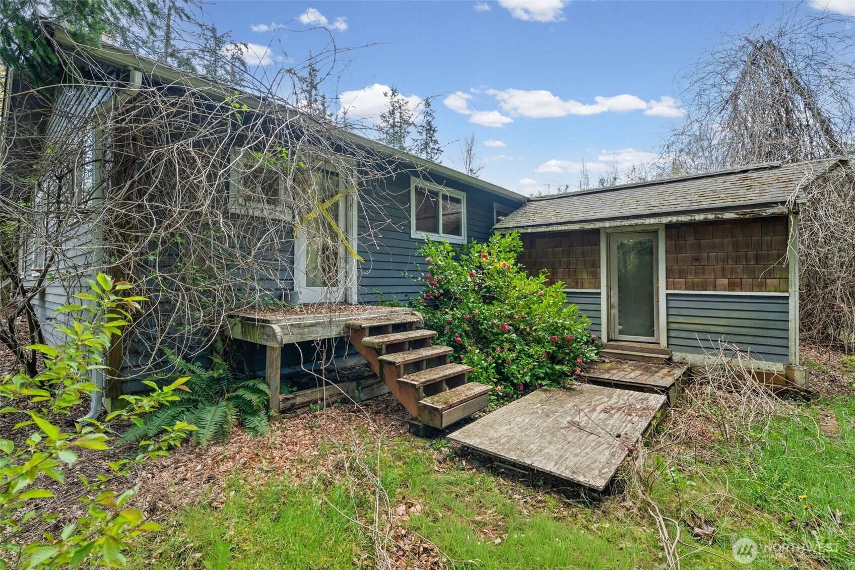 Rear deck and exterior spaces offer a great footprint for outdoor living and entertaining. Ready for repair or rebuild to maximize potential.