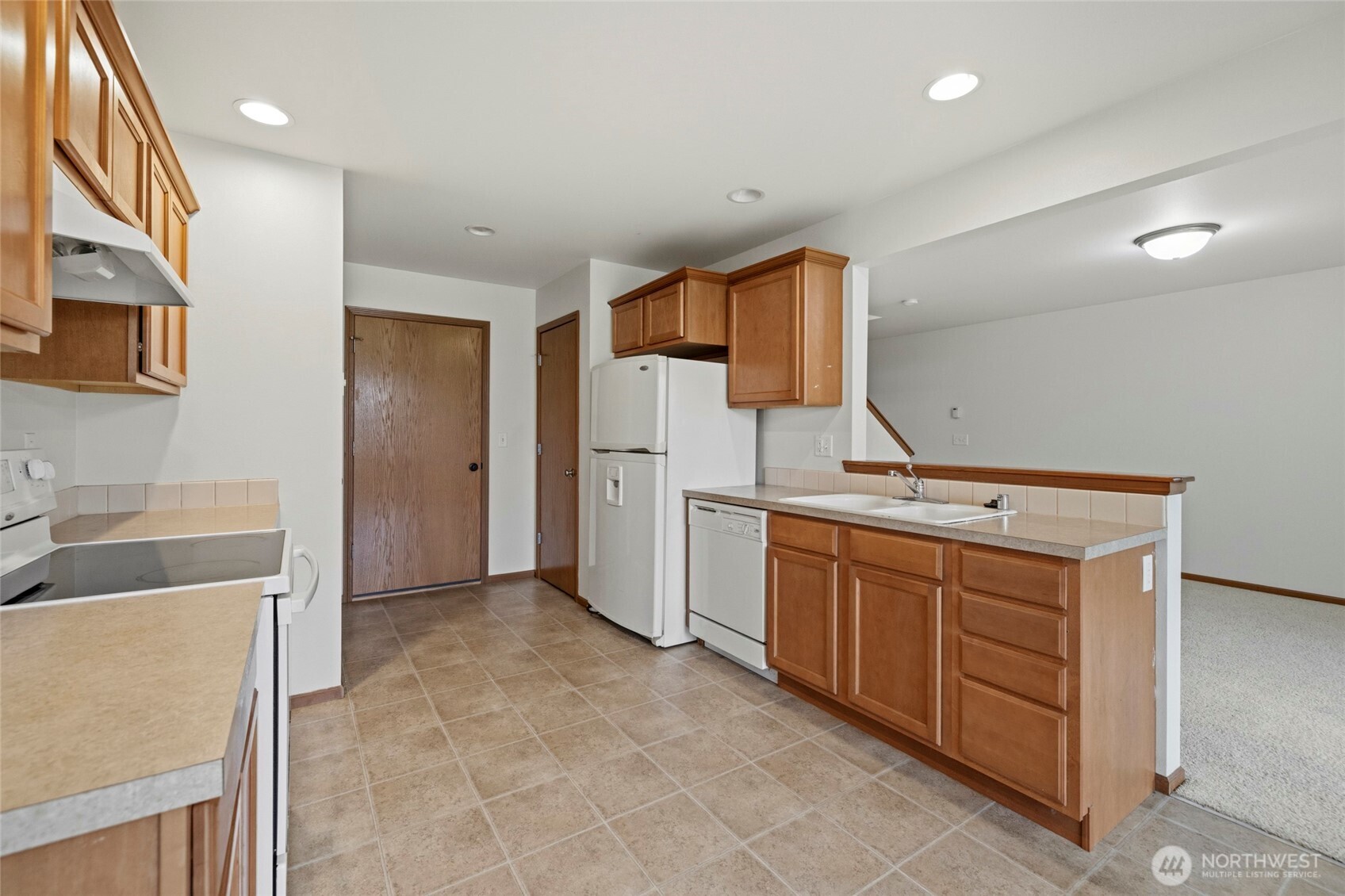 Pantry, half bathroom and garage off the kitchen
