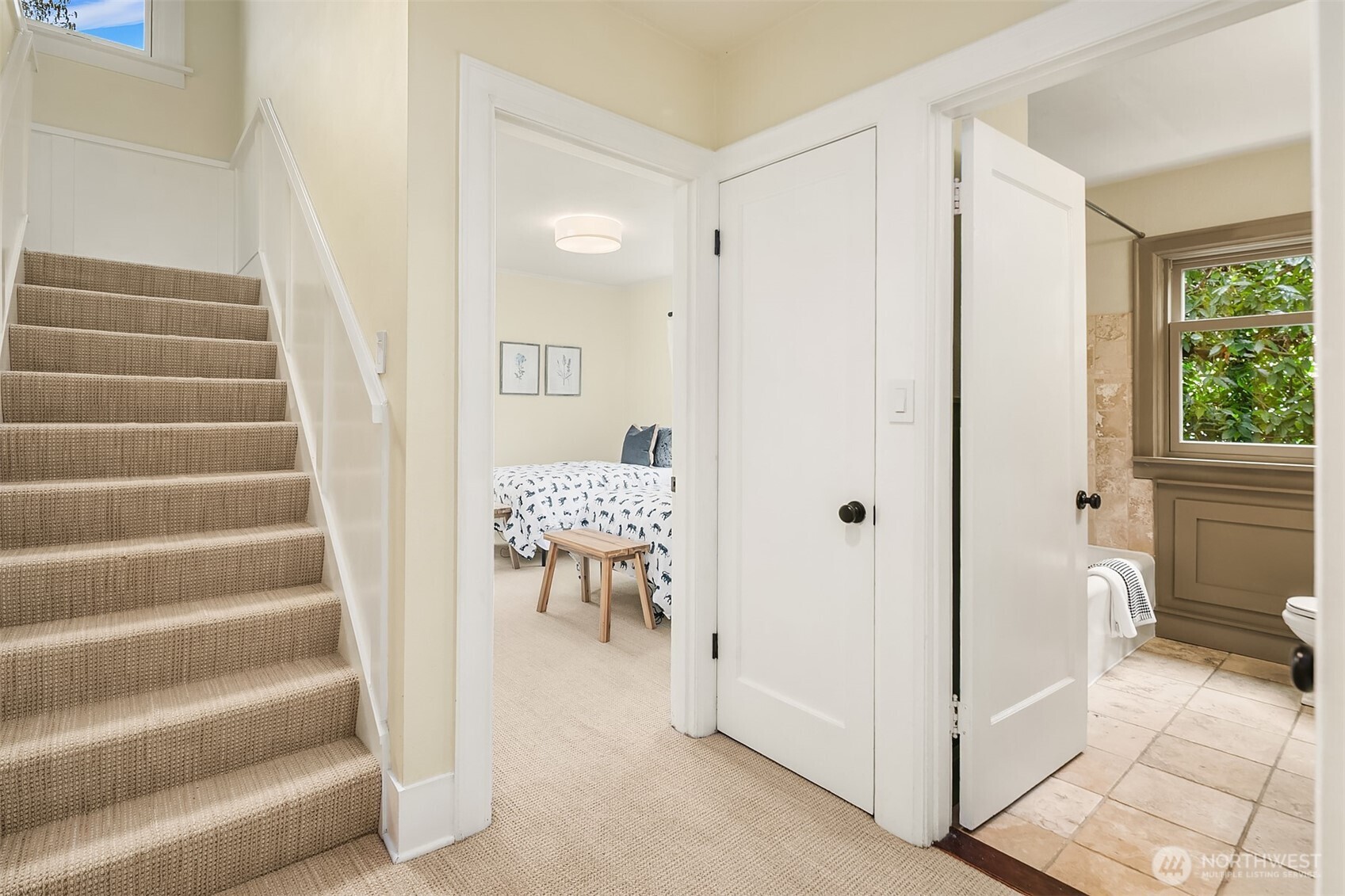 Staircase to second level with two bedrooms and full bath on main level.