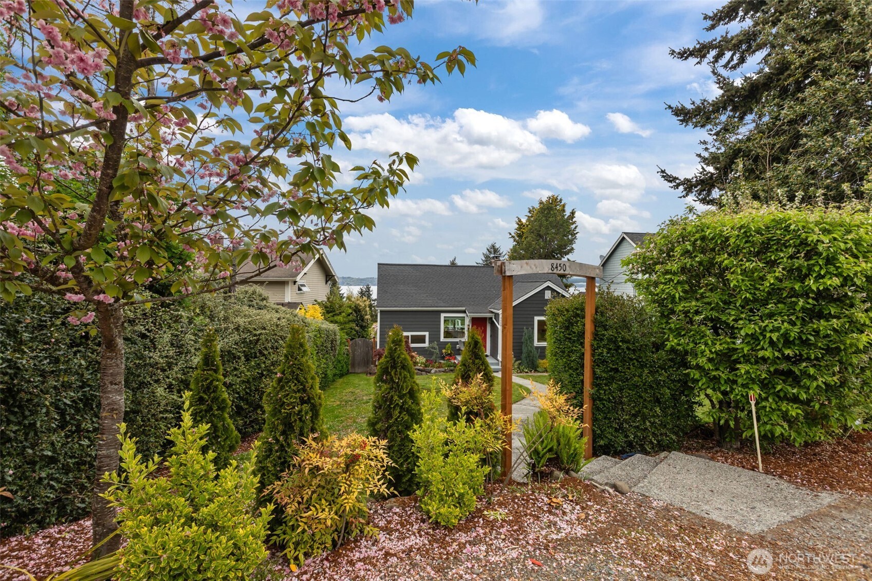 This inviting home features vaulted wood ceilings, warm natural textures, and a stunning picture window framing expansive water views. The elevated deck offers the perfect vantage point to enjoy the beauty of the Sound year-round.