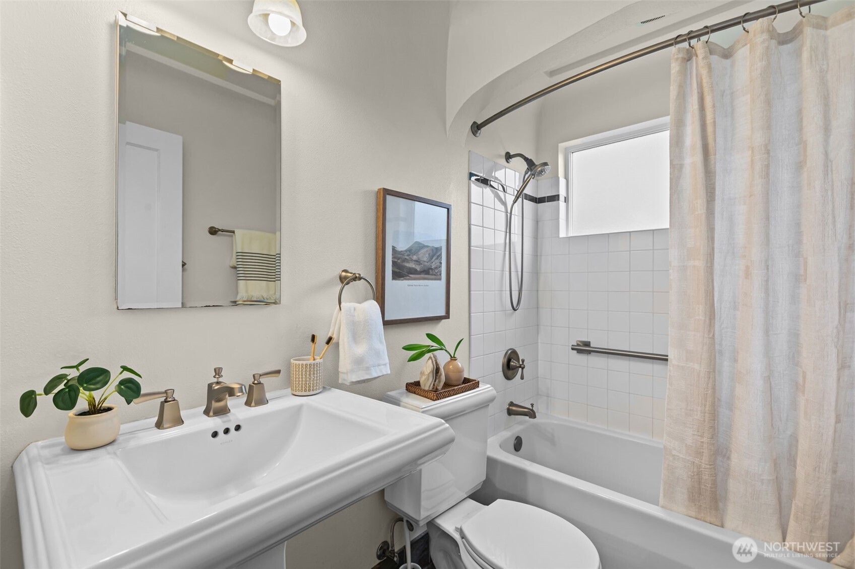 Pedestal sink and full bath. White tile and grout.
